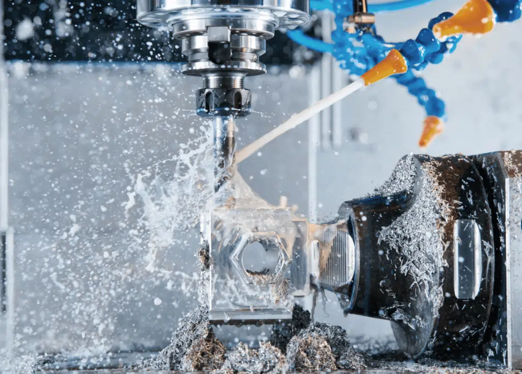 CNC machine cutting metal with coolant spraying, surrounded by metal shavings in a bustling Industrie setting.